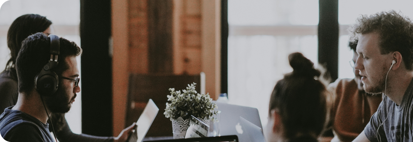 people in an office working on laptops
