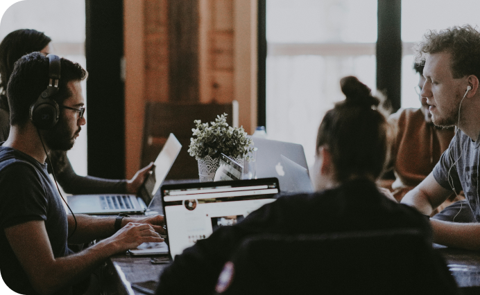people in an office working on laptops