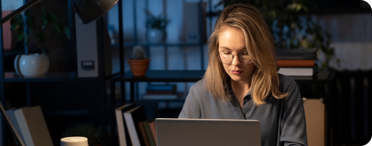 woman sitting and working on a laptop