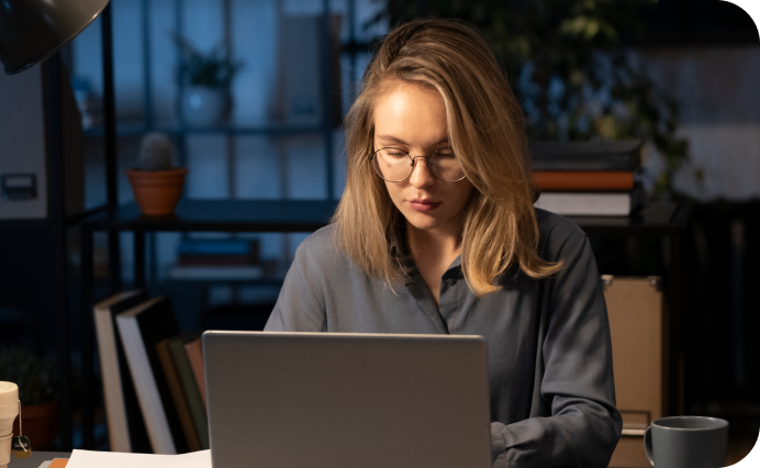 woman sitting and working on a laptop