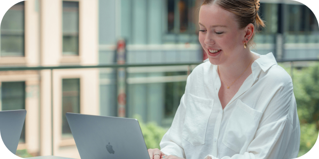 a woman sitting working on a laptop